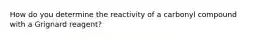 How do you determine the reactivity of a carbonyl compound with a Grignard reagent?