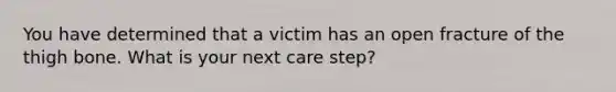 You have determined that a victim has an open fracture of the thigh bone. What is your next care step?