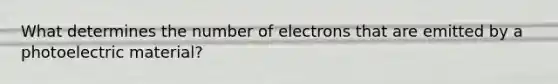 What determines the number of electrons that are emitted by a photoelectric material?