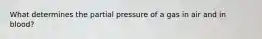 What determines the partial pressure of a gas in air and in blood?