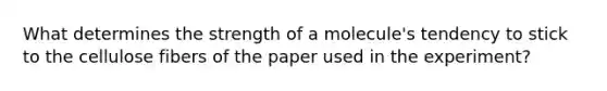 What determines the strength of a molecule's tendency to stick to the cellulose fibers of the paper used in the experiment?