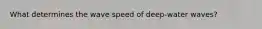 What determines the wave speed of deep-water waves?