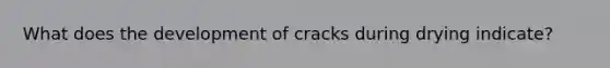 What does the development of cracks during drying indicate?