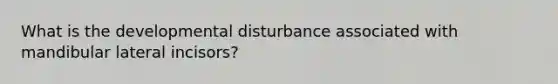 What is the developmental disturbance associated with mandibular lateral incisors?