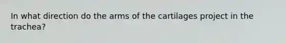 In what direction do the arms of the cartilages project in the trachea?