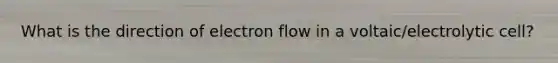 What is the direction of electron flow in a voltaic/electrolytic cell?