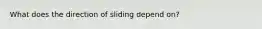 What does the direction of sliding depend on?