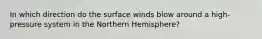 In which direction do the surface winds blow around a high-pressure system in the Northern Hemisphere?