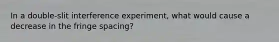 In a double-slit interference experiment, what would cause a decrease in the fringe spacing?