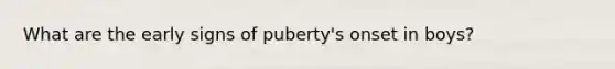 What are the early signs of puberty's onset in boys?