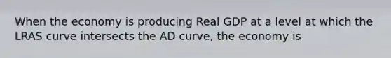 When the economy is producing Real GDP at a level at which the LRAS curve intersects the AD curve, the economy is