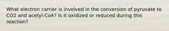 What electron carrier is involved in the conversion of pyruvate to CO2 and acetyl-CoA? Is it oxidized or reduced during this reaction?