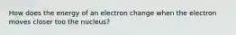 How does the energy of an electron change when the electron moves closer too the nucleus?