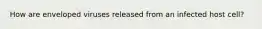 How are enveloped viruses released from an infected host cell?