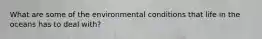 What are some of the environmental conditions that life in the oceans has to deal with?