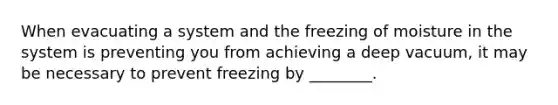 When evacuating a system and the freezing of moisture in the system is preventing you from achieving a deep vacuum, it may be necessary to prevent freezing by ________.