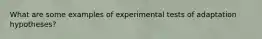 What are some examples of experimental tests of adaptation hypotheses?