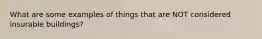 What are some examples of things that are NOT considered insurable buildings?