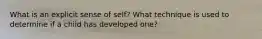 What is an explicit sense of self? What technique is used to determine if a child has developed one?