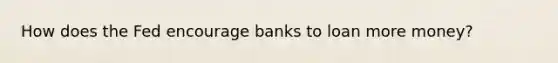 How does the Fed encourage banks to loan more money?