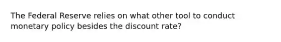 The Federal Reserve relies on what other tool to conduct monetary policy besides the discount rate?