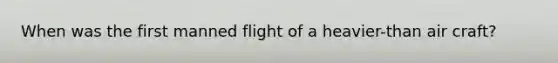 When was the first manned flight of a heavier-than air craft?