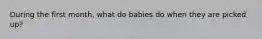 During the first month, what do babies do when they are picked up?