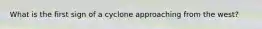 What is the first sign of a cyclone approaching from the west?