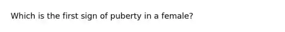 Which is the first sign of puberty in a female?