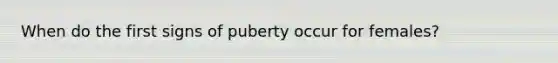 When do the first signs of puberty occur for females?