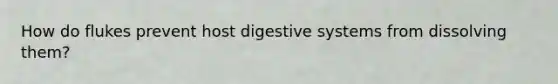 How do flukes prevent host digestive systems from dissolving them?