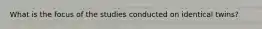 What is the focus of the studies conducted on identical twins?