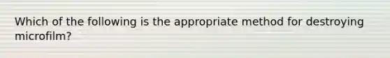 Which of the following is the appropriate method for destroying microfilm?