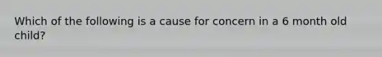 Which of the following is a cause for concern in a 6 month old child?