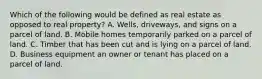 Which of the following would be defined as real estate as opposed to real property? A. Wells, driveways, and signs on a parcel of land. B. Mobile homes temporarily parked on a parcel of land. C. Timber that has been cut and is lying on a parcel of land. D. Business equipment an owner or tenant has placed on a parcel of land.