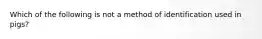 Which of the following is not a method of identification used in pigs?