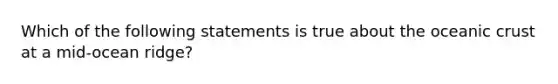 Which of the following statements is true about the oceanic crust at a mid-ocean ridge?