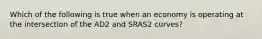 Which of the following is true when an economy is operating at the intersection of the AD2 and SRAS2 curves?