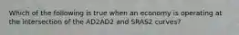 Which of the following is true when an economy is operating at the intersection of the AD2AD2 and SRAS2 curves?