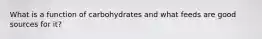 What is a function of carbohydrates and what feeds are good sources for it?