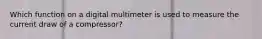 Which function on a digital multimeter is used to measure the current draw of a compressor?