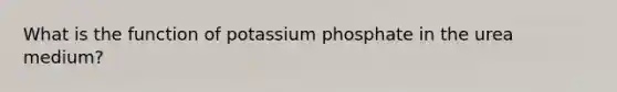 What is the function of potassium phosphate in the urea medium?