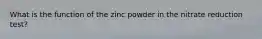 What is the function of the zinc powder in the nitrate reduction test?
