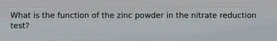 What is the function of the zinc powder in the nitrate reduction test?