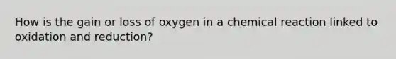 How is the gain or loss of oxygen in a chemical reaction linked to oxidation and reduction?