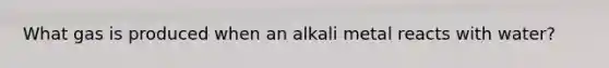 What gas is produced when an alkali metal reacts with water?