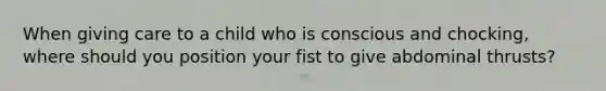 When giving care to a child who is conscious and chocking, where should you position your fist to give abdominal thrusts?