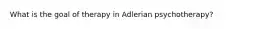 What is the goal of therapy in Adlerian psychotherapy?