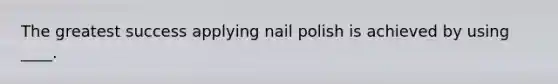 The greatest success applying nail polish is achieved by using ____.