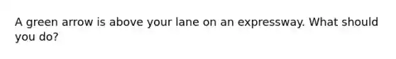 A green arrow is above your lane on an expressway. What should you do?